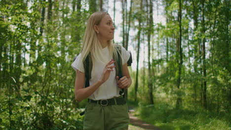 Woman-young-blonde-looks-at-forest-beauty-while-traveling